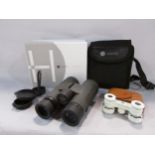 A very good pair of waterproof Hawke Vantage binoculars with shoulder case and strap with its