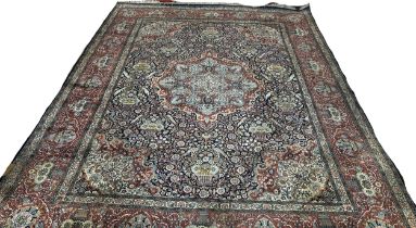 A large Fine Persian cotton and silk carpet with a central floral medallion and with all over floral