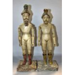 An unusual near pair of 19th century Italian carved wooden figures with integral painted helmet