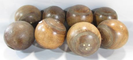 Eight vintage weighted wooden bowls.