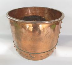 An antique copper cauldron with a riveted base section, 41cm diameter x 32cm high.