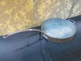 An outsized copper saucepan with iron handle, 48cm diameter
