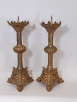 A matched pair of 19th century gilt brass ecclesiastical pricket candle sticks, with open acanthus