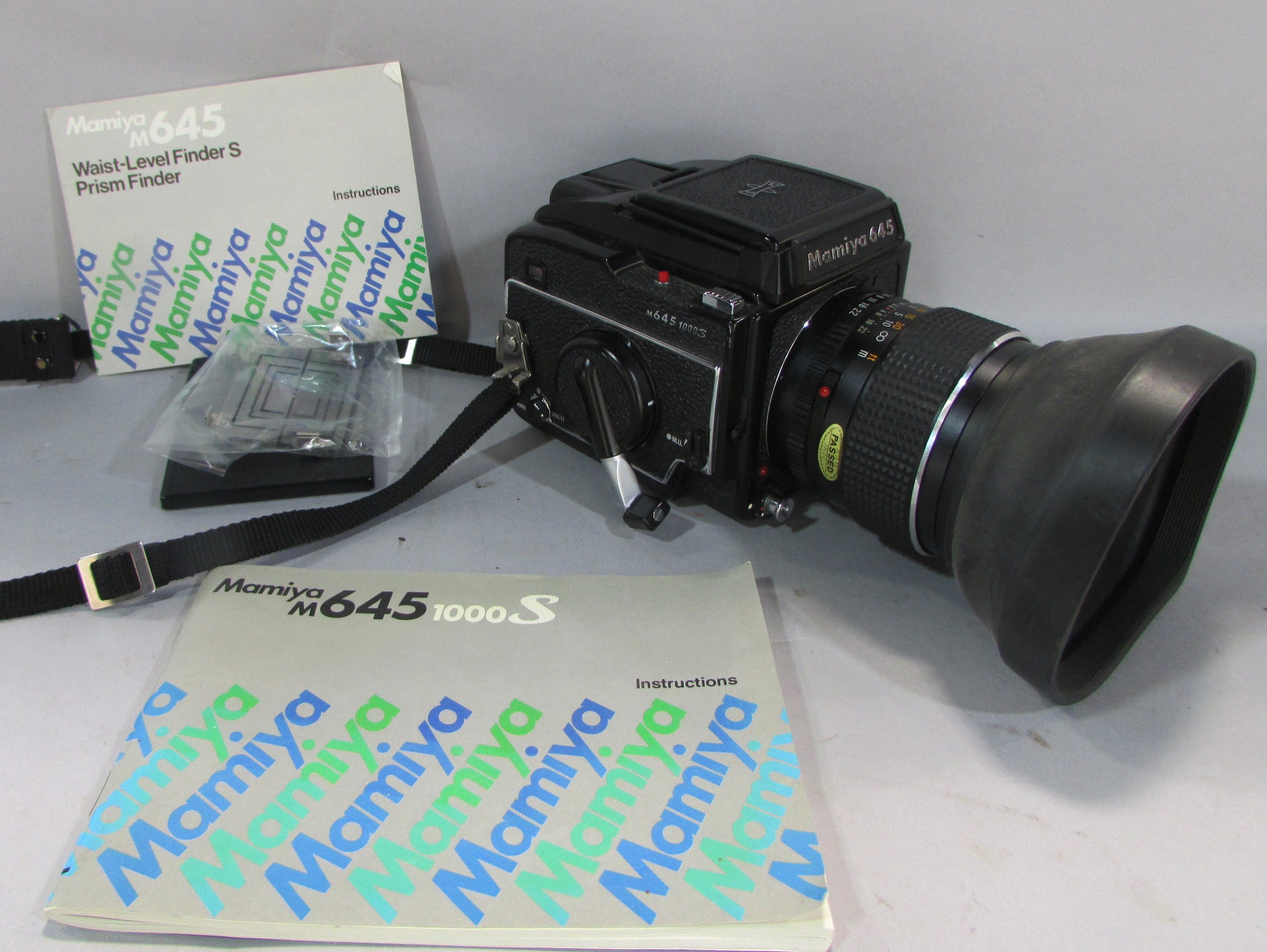 A Mamiya M645 box camera , M645 waist level finder and instruction booklet