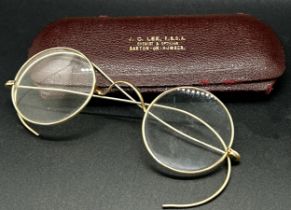 A pair of antique yellow metal wire framed spectacles with case