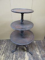 A George III mahogany three tier dumb waiter on turned column and tripod base, 112cm high