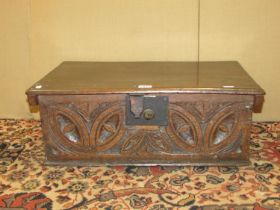 An 18th century oak bible box with carved front frieze, steel lock plate and hasp, 57cm wide