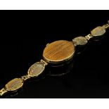 Accurist: A lady's 9ct yellow gold wristwatch, with oval mother-of-pearl dial with dotted markers