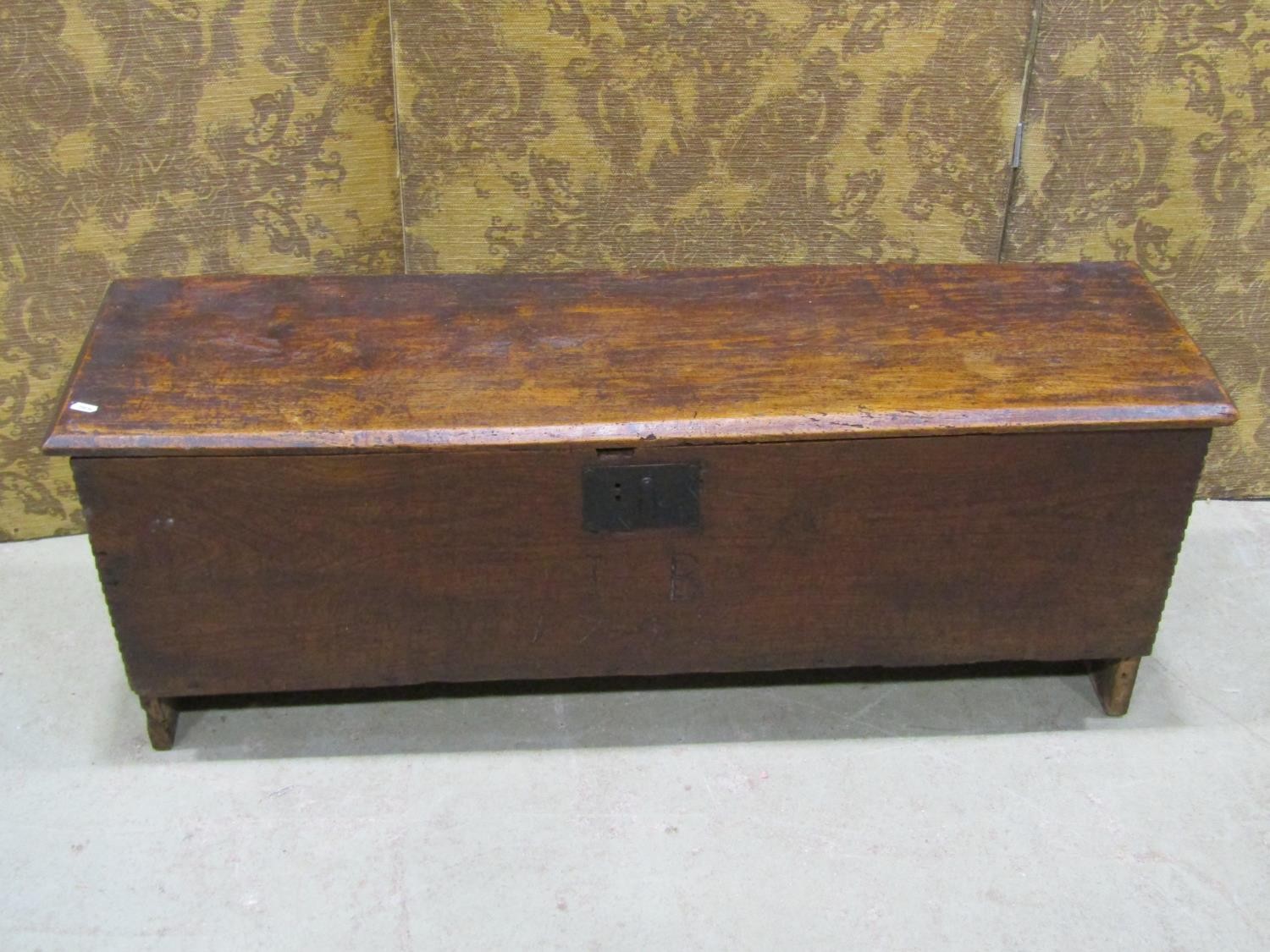 An 18th century elm six plank coffer, monogrammed I B and dated 1752, 113cm long