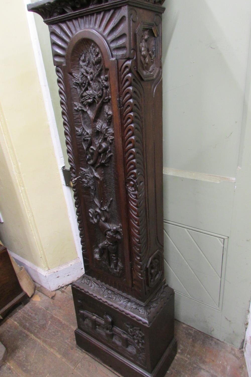 A 19th century oak longcase clock with heavy estate carving, the trunk detailing a knight fighting - Image 16 of 17