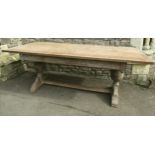 Oak refectory table in the Heals manner, raised on a pair of baluster supports, with fumed finish,