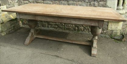 Oak refectory table in the Heals manner, raised on a pair of baluster supports, with fumed finish,