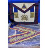 Masonic Regalia of a collection of elaborately decorated aprons, with Masonic symbols, gold braid,