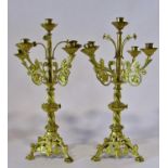 A pair of continental ecclesiastical gilt metal five light alter / table candelabra, with