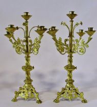 A pair of continental ecclesiastical gilt metal five light alter / table candelabra, with