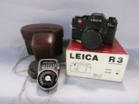A Leica R3 electronic camera in its original box and leather case, together with a Sangamo Weston