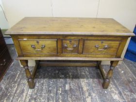 A good quality contemporary Georgian style side table incorporating three drawers on turned