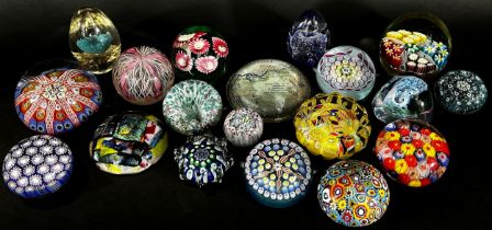 A collection of 19, 20th century, glass paperweights in varying designs Millefiori, flowers, bubbles