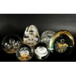 A collection of 19th, 20th century, glass paperweights mainly of clear glass design, bubbles and