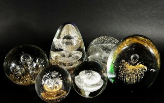 A collection of 19th, 20th century, glass paperweights mainly of clear glass design, bubbles and