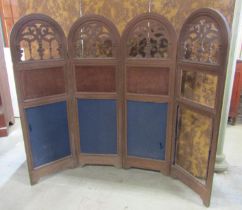 A 19th century oak framed four panelled room divider with arched and pierced panels and further