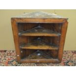 An early oak hanging corner cupboard, the carved face with geometric detail, and dated 1702, set