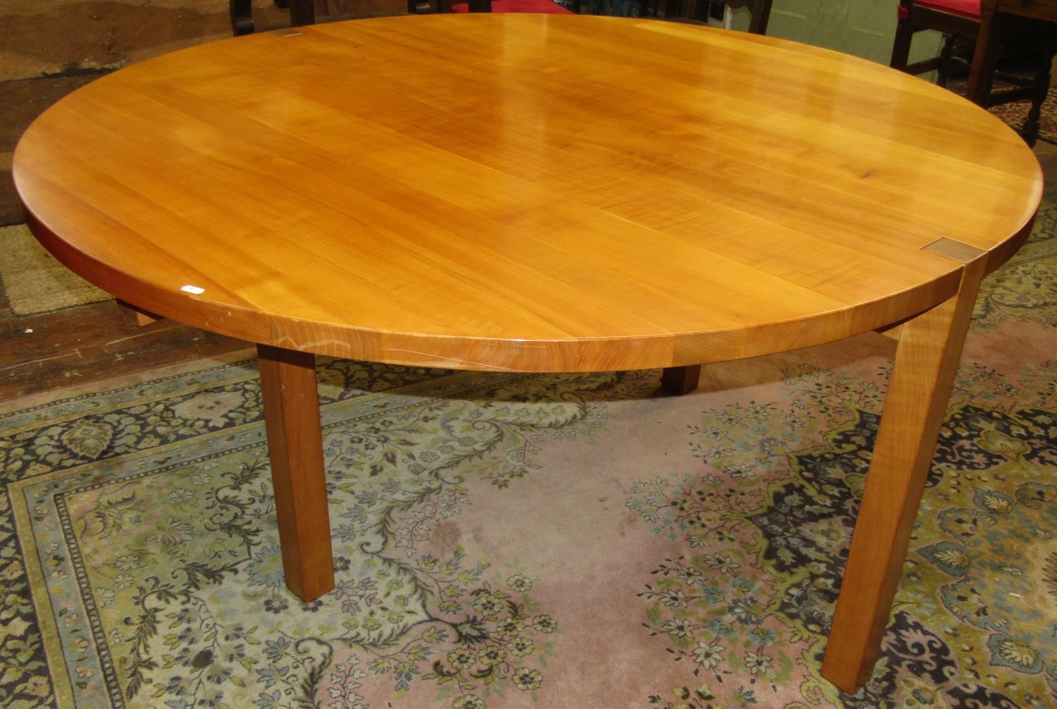 A bespoke made John Makepeace table and chairs made in English wild cherry wood, the circular