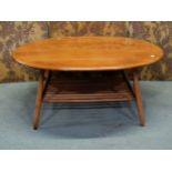 An Ercol occasional table of oval form, on turned supports with under gallery, with well figured elm