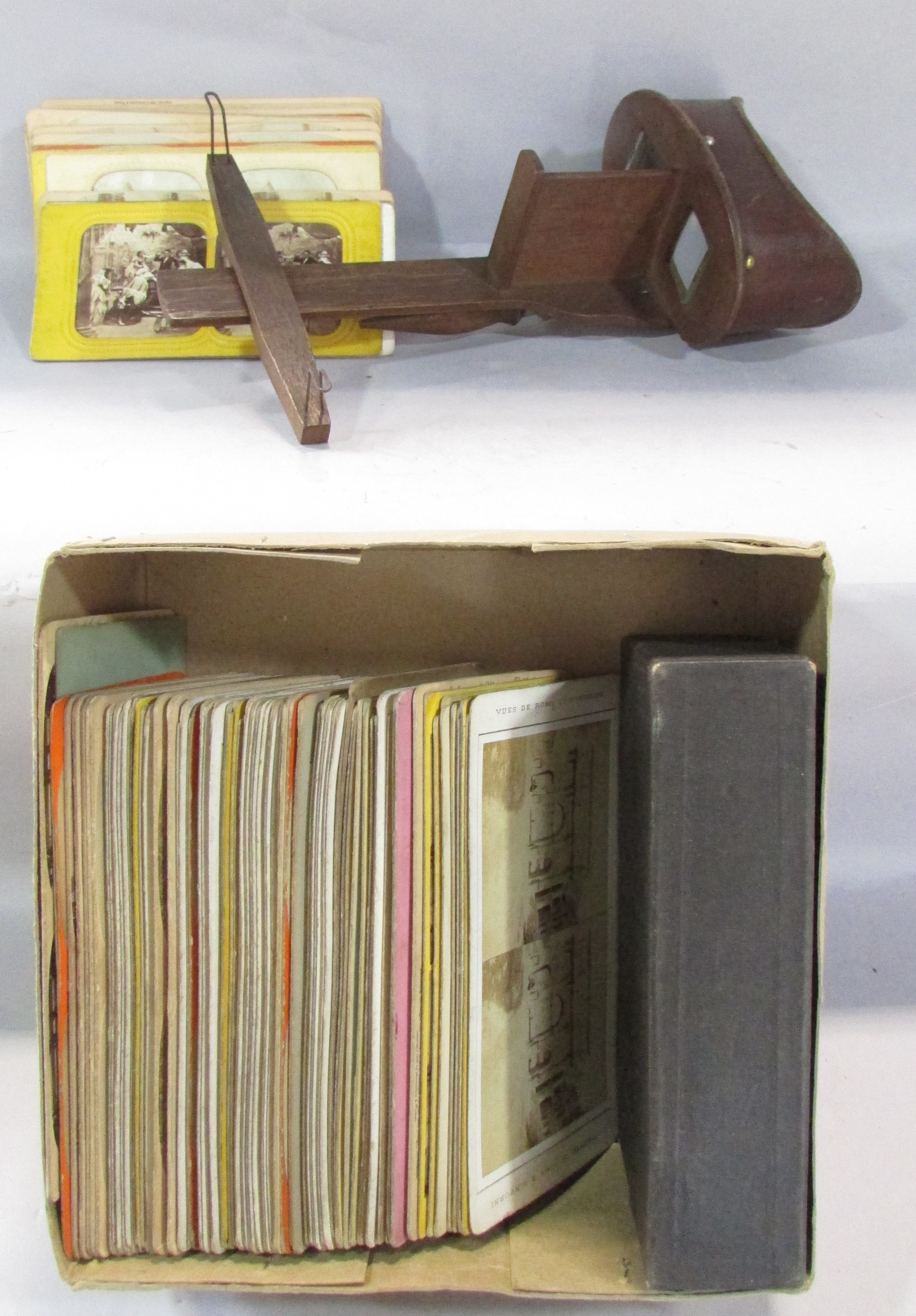 A Victorian Stereoscopic viewer, with a selection of topographical cards, rural landscapes,
