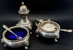 A silver three piece Georgian style condiment set, salt, pepper and mustard with two spoons and blue