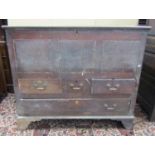 An 18th century oak mule chest, the rising lid over three simple panels and an arrangement of one