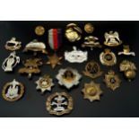A small collection of cap badges, to include Military Police, Royal Army Service Corp,