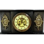 A Victorian black slate cased mantle clock