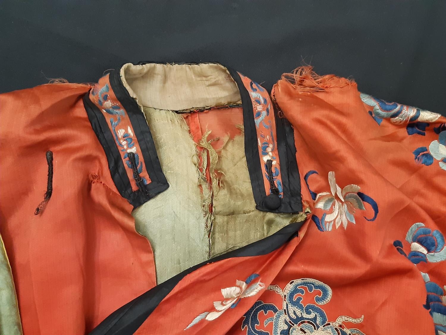 A late 19th/ early 20th century Chinese robe of red silk embroidered with flowers, moths and other - Image 8 of 8