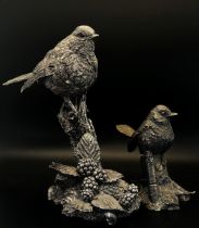 Two silver overlaid birds, one perched on blackberries, 17cm high the other perched on a stump, 11cm