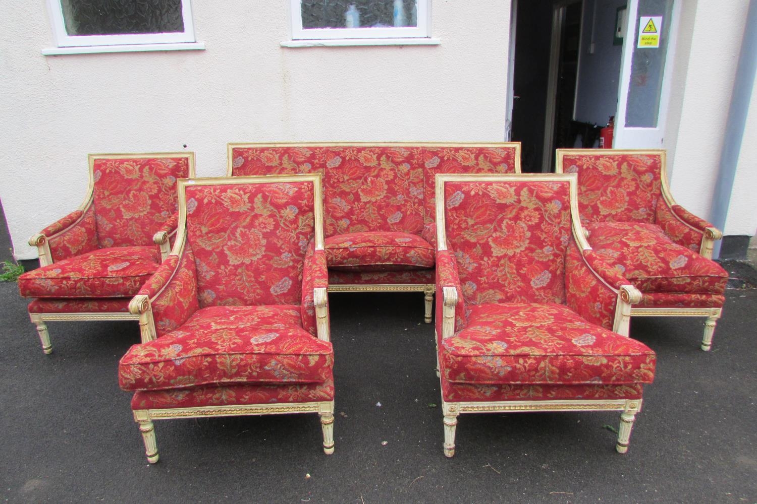 A French drawing room suite comprising a three seat sofa and four matching tub chairs, the frames