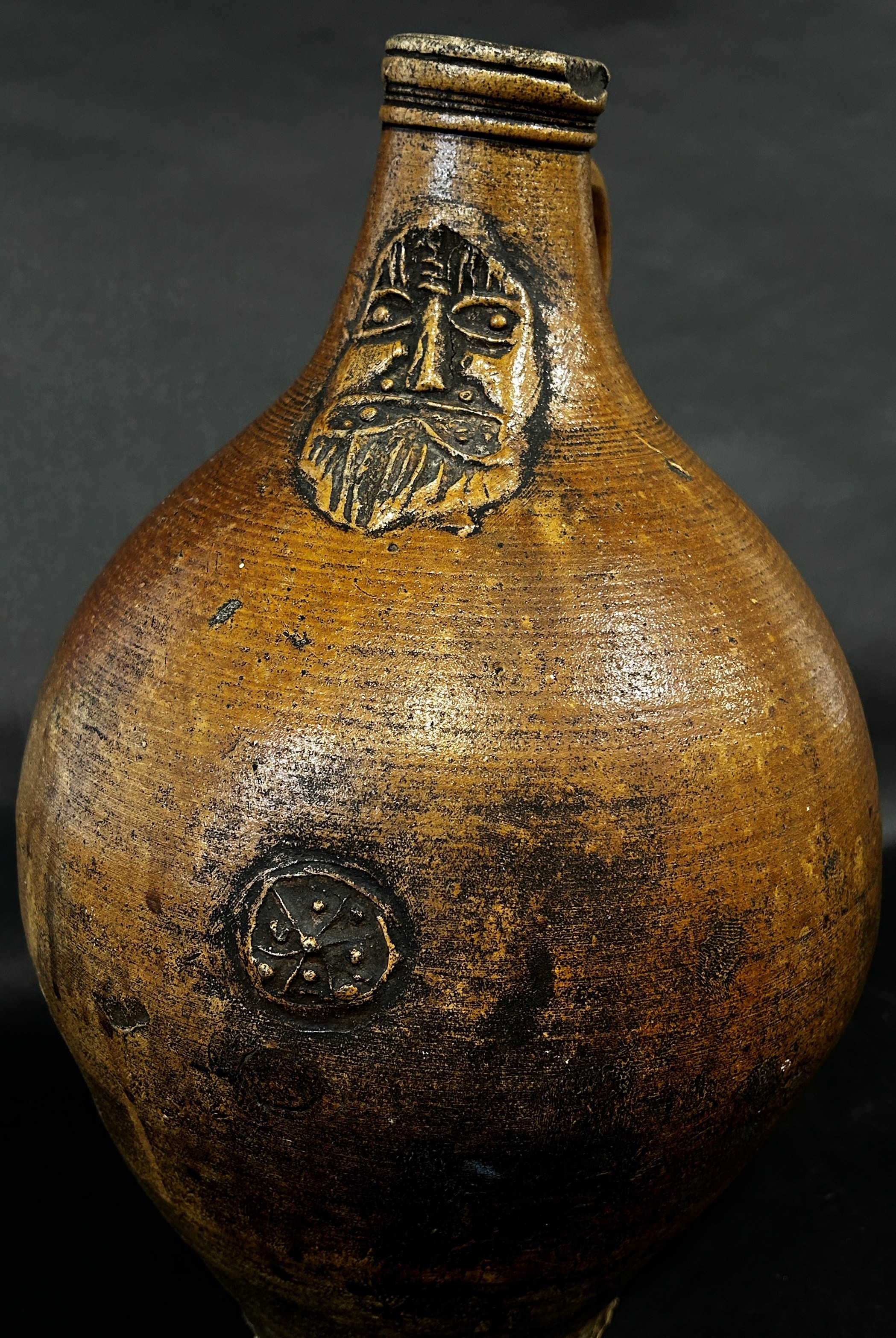 A stoneware Bellarmine with moulded face and symbol, 37cm high - Image 2 of 4