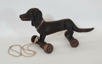 Vintage wooden pull along Dachshund dog toy with moving ears and articulated centre