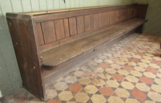 A large Victorian pine church pew with panelled back, 3.5m long