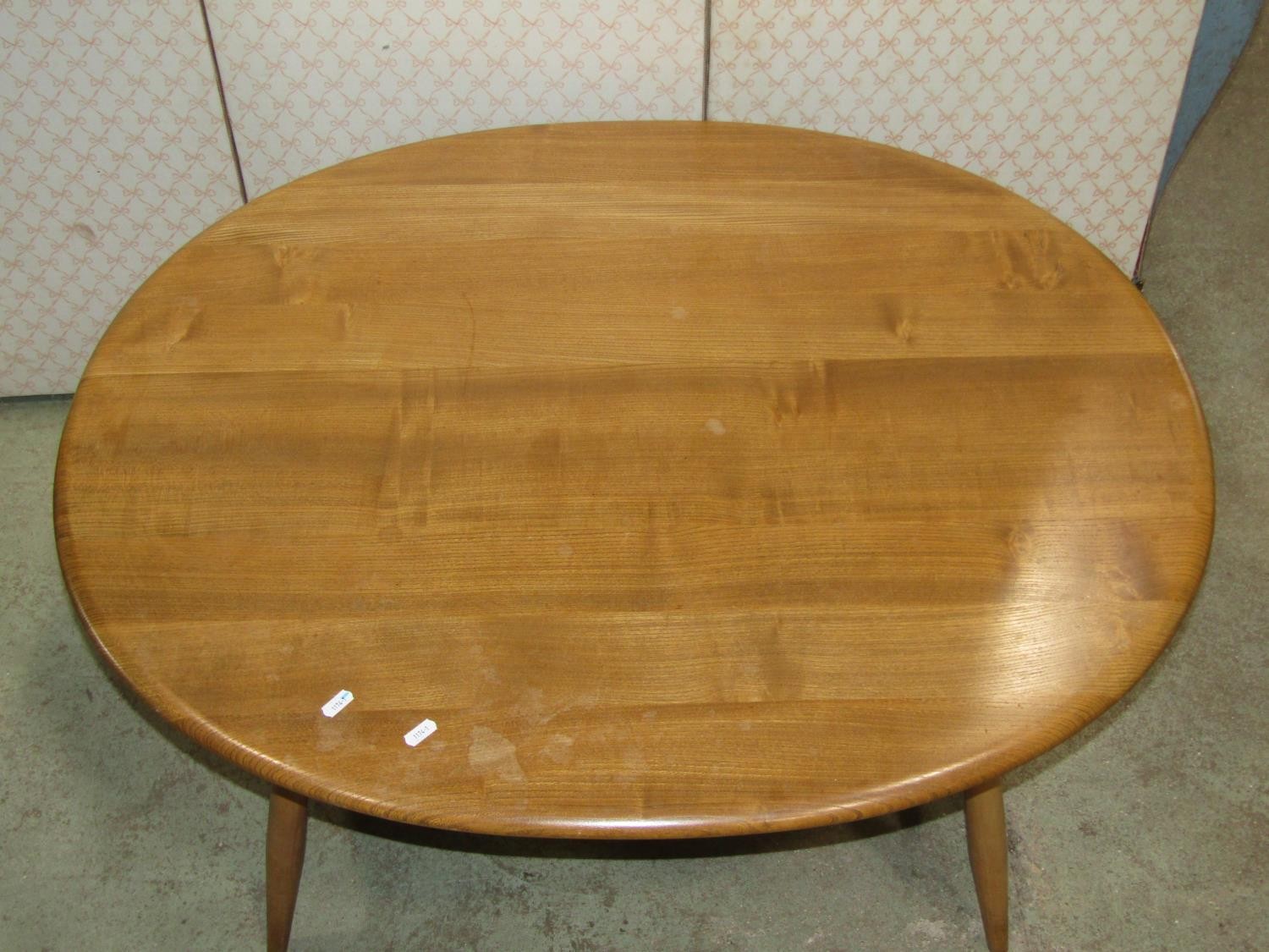 An Ercol occasional table principally in elm, the oval top 100cm max - Image 2 of 3