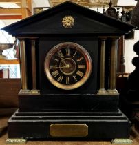 A Victorian black slate mantle clock with column supports and eight-day time piece, brass