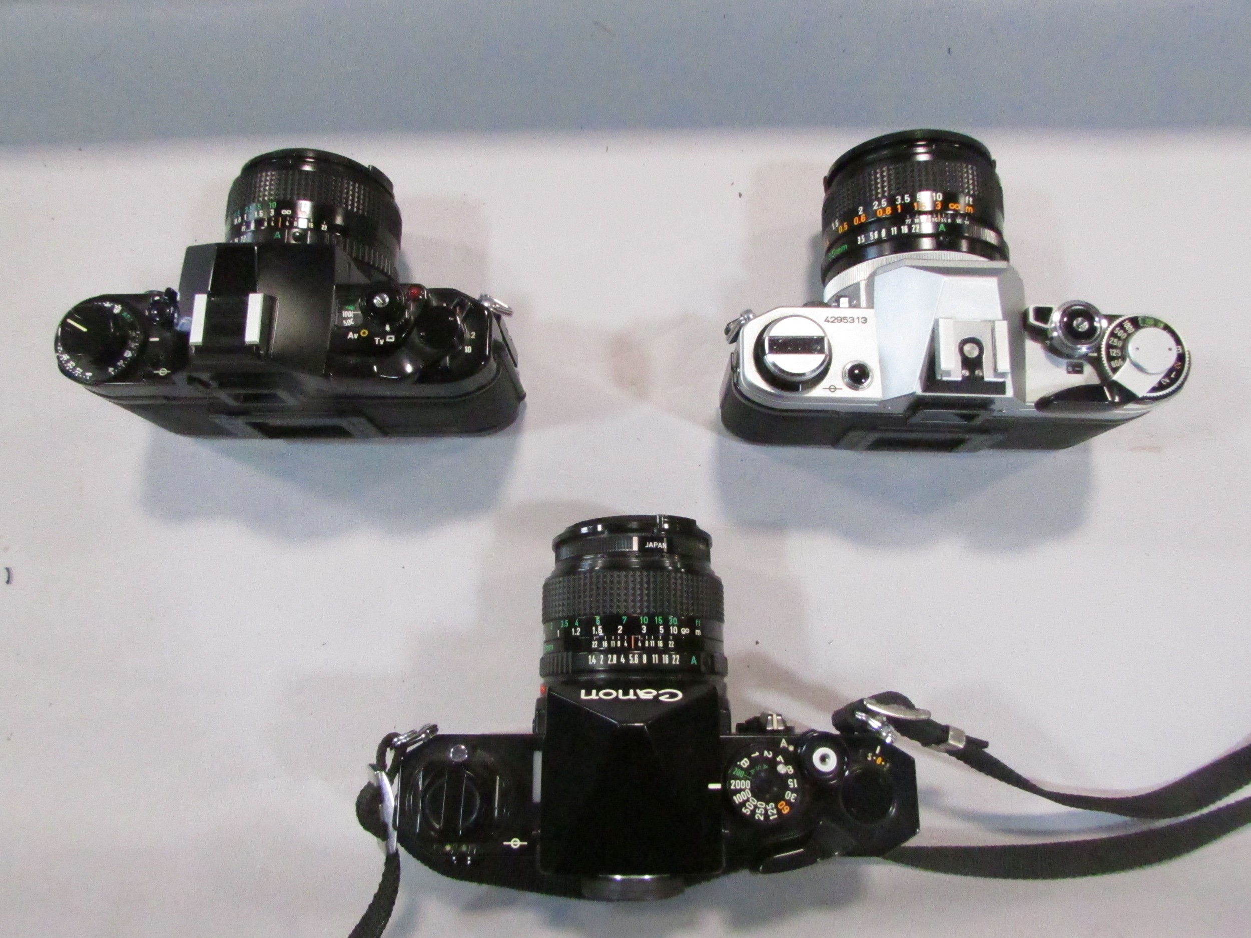 Three Canon cameras: models A1, AE1, F1, together with a 135 millimetre lens, 20 mm lens, all - Image 3 of 5