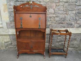 An early 20th century oak students bureau with strap hinges, the raised back with pierced detail