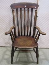 A Windsor lathe back elbow chair principally in elm and beech wood