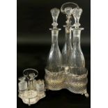 A 19th century silver plated three bottle decanter stand with three slender facetted cut glass