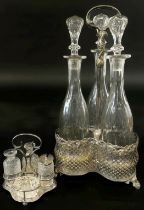 A 19th century silver plated three bottle decanter stand with three slender facetted cut glass