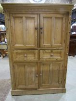 A 19th century stripped and waxed pine food cupboard of full height enclosed by two pairs of