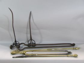 A substantial pair of 19th century rusty wrought iron coal tongs, together with three similar fire