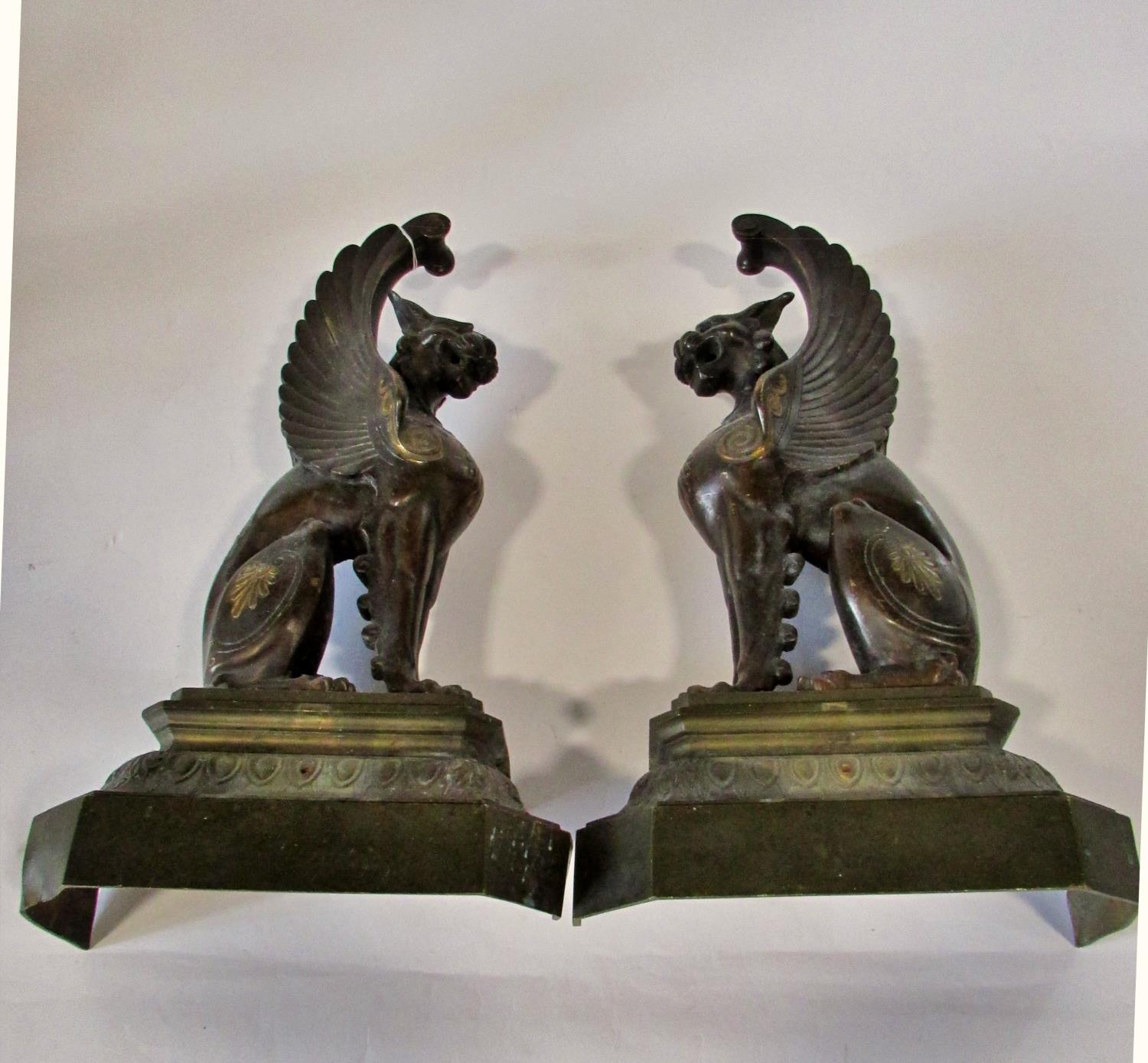 A substantial pair of 19th century cast bronze gryphons, seated in profile, raised on stepped