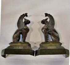 A substantial pair of 19th century cast bronze gryphons, seated in profile, raised on stepped